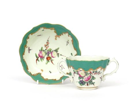 A Worcester two-handled chocolate cup and saucer  c.1770, painted with arrangements of spotted fruit, amid scattered leaf spr