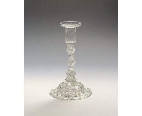 A glass candlestick  c.1750, with a pan-topped moulded nozzle above a multi-knopped airtwist stem over an annulated knop and 