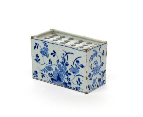 A delftware flower brick  c.1760, of rectangular form, painted in blue with sprays of peony, chrysanthemum and other Oriental