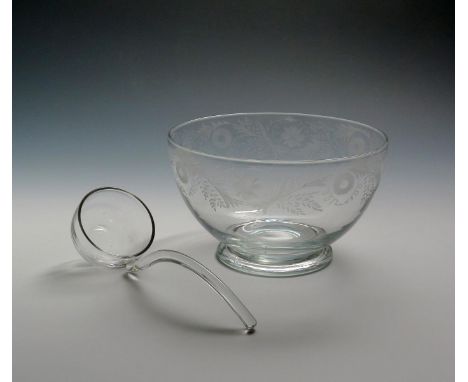 A glass punch bowl c.1770, engraved with a continuous border of flowers and leaf sprays, raised on a low foot, with a later g