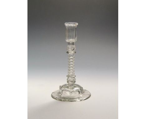 A rare glass candlestick  c.1750, the ribbed cylindrical nozzle raised on a composite stem of a corkscrew airtwist between be
