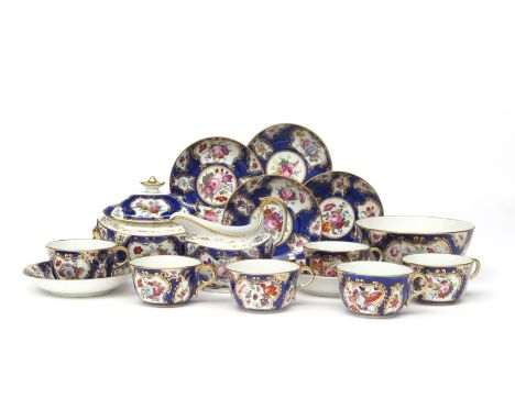 A Coalport part tea service  early 19th century, painted with sprays of flowers within gilt cartouches on a blue ground. Comp