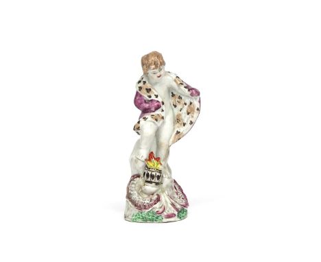 A Plymouth figure of Winter c.1770, modelled as a putto wearing a fur-lined cloak and standing over a flaming brazier, raised