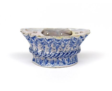 A Delftware bough pot  c.1750, possibly English, of fluted D shape, painted in blue with a formal floral design above a ropet