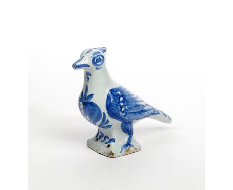A Nevers faïence bird finial dated 1751, modelled as a large pigeon with plumage picked out in blue, inscribed '1751' to the 