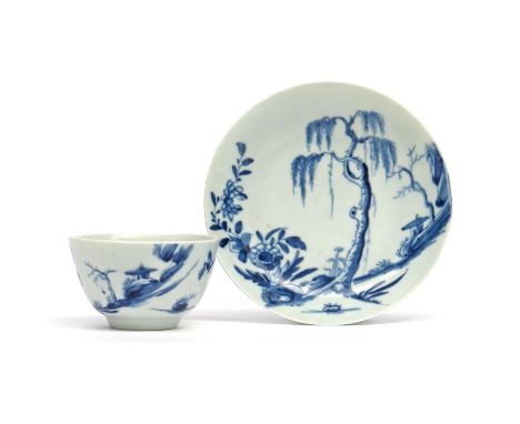 A good Worcester blue and white teabowl and saucer  c.1755-58, finely painted with the Landslip pattern, a tall willow in the