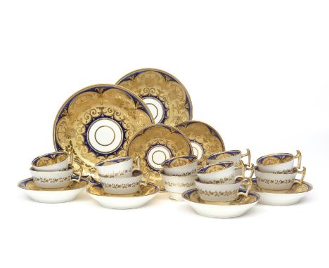 An English porcelain part tea service  early 19th century, richly decorated with gilt foliate scrolls on a pale peach ground 