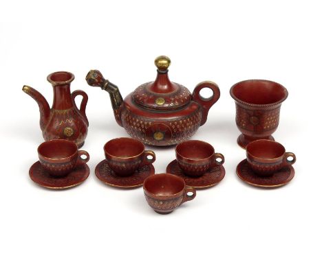 A Tophane pottery part tea service  late 19th century, Turkey, the polished ground incised with a design of overlapping leave