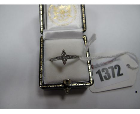A Modern Marquise Cut Single Stone Diamond ring, high set between uniform inset shoulders, stamped "585".