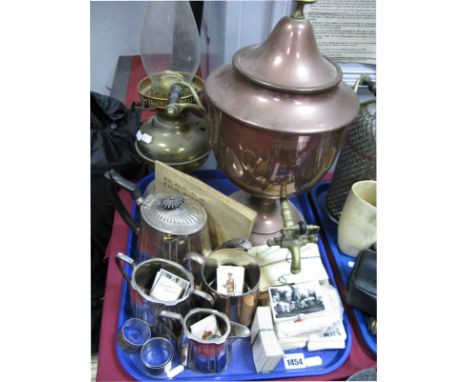 A Copper Tea Urn with Brass tap, finial and twin handles, a brass parafin lamp, three piece electroplated tea set, kensitas s