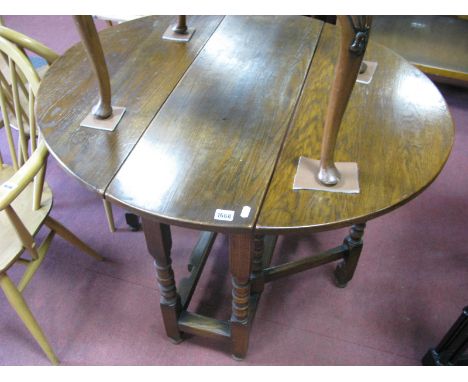 An Oak Drop Leaf Gate Leg Table, oval top, on ring turned and block stretchered legs.