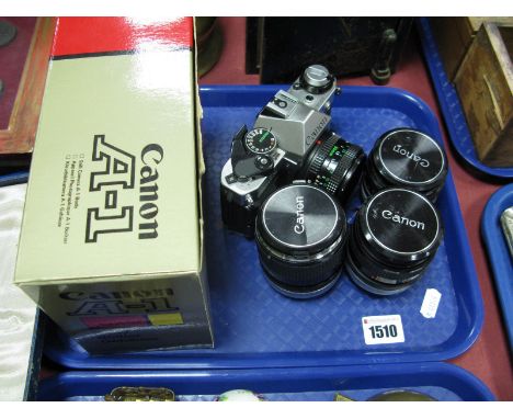 A Canon AE-1 Program Camera, with a 50mm 1:1.8 lens, a Canon A1 camera (boxed, body only) and three Canon lenses including 50