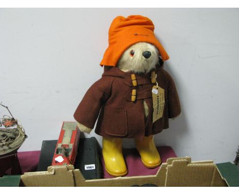 A Gabrielle 'Paddington Bean' Bear, orange hat, brown duffle coat with ticket, yellow boots, (moulded 'Dunlop' to sole's), a 