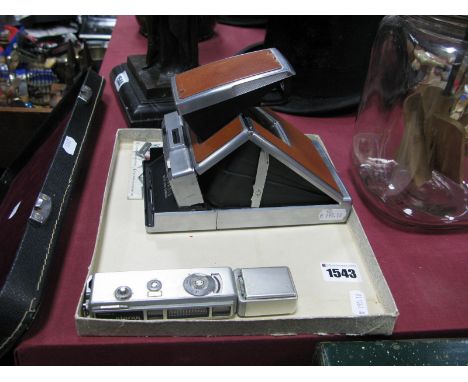 A Polaroid SX-70 Land Camera (with Operating Card), and a Yashica Atoron pocket 'spy' camera (2)