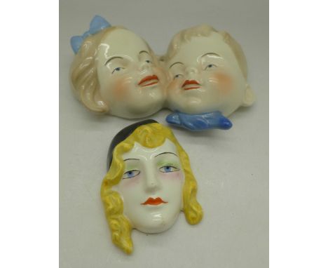 Two face mask plaques, Goebel and one other continental, width of largest 13cm