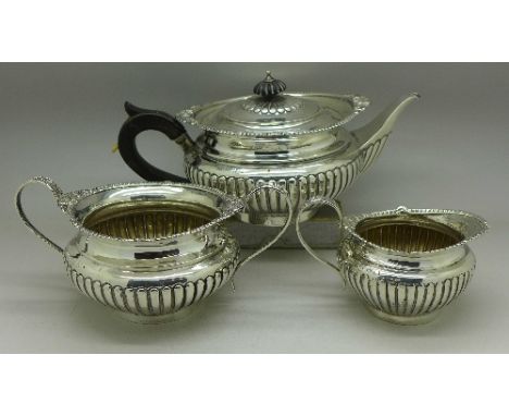 A matched three piece silver tea service, tea pot and cream hallmarked Birmingham 1899 by George Unite, the sugar hallmarked 