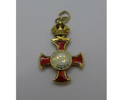 A small yellow metal and enamel cross medal, tests as 18ct gold