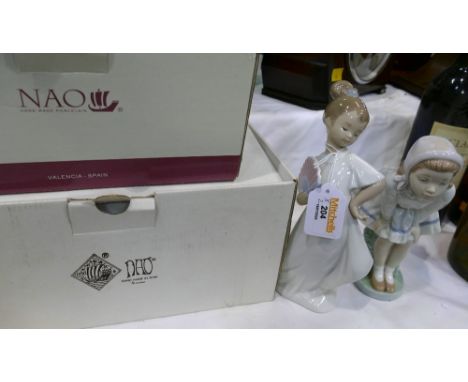 Two Nao figurines with boxes
