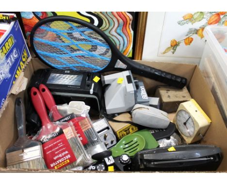 Box of electric fly swatter, HP Photosmart A636, The Button Polaroid camera, radio, vintage alarm clock etc