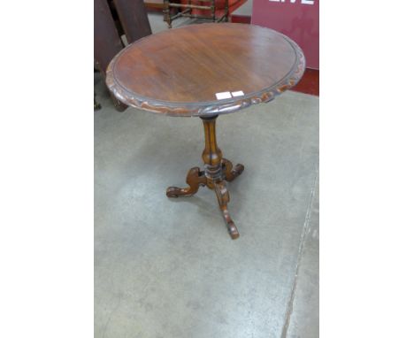 A Victorian walnut circular tripod tea table