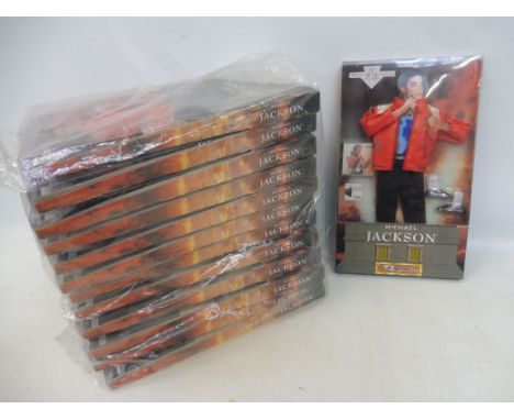 13 new old stock Michael Jackson outfit sets to accompany a figure, with musical element for fitting into a doll.