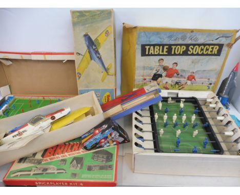 A quantity of mixed era toys to include a Tri-ang PT19 Trainer, Chad Valley football skills and others.