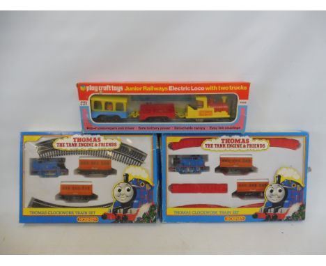 Two Hornby Thomas the Tank Engine clockwork trains and a Playcraft Junior set.