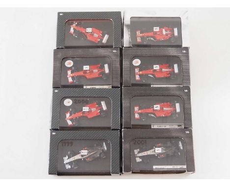 A group of 1:43 scale Formula 1 race cars by HOTWHEELS, comprising of 1990s and early 2000s Ferrari and McLaren Formula 1 rac