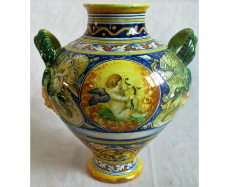 A Cantagalli majolica vase, with armorial crest and trophy, fitted serpent handles. Condition Report: Some flaking to the gla