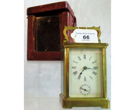 A 20th century brass cased carriage clock, having four glass panels with carrying handle in associated case., Condition Repor