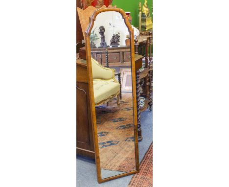 AN ANTIQUE WALNUT FRAMED SHAPED MIRROR 120cm high x 33cm approximately