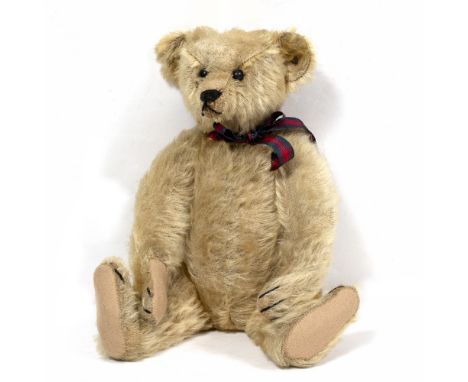 AN EARLY 20TH CENTURY, POSSIBLY 1907, STEIFF BEAR blonde mohair with script button to right ear, 34cm overall 