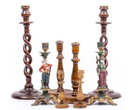 A PAIR OF PAINTED SPELTER CANDLESTICK of figural form, each 26cm high; a pair of barley twist mahogany candle sticks, each 41
