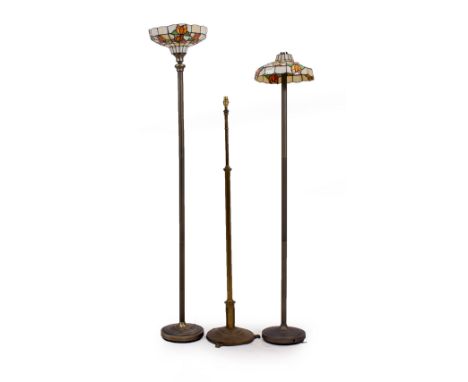AN ANTIQUE BRASS EXTENDING LAMP STANDARD 139cm high together with two modern lamp standards with leaded glass shades (3)