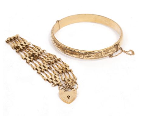 A 9 CARAT YELLOW GOLD BANGLE with engraved decoration, a 9 carat gold gate bracelet, overall weight 21 grams approximately (2