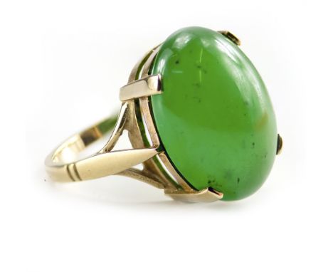 A 9 CARAT YELLOW GOLD MOUNTED JADE CABOCHON SET RING size O/P, 6.5 grams in weight approximately overall