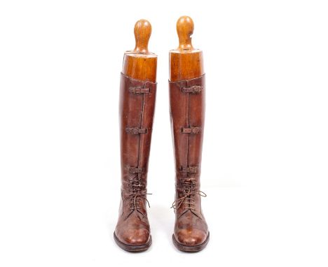 A PAIR OF VINTAGE LEATHER EQUESTRIAN BOOTS and Watts &amp; Co treen boot lasts, 62cm high overall