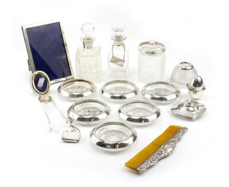 A COLLECTION OF SILVER  to include two silver collared bottles, photoframes, ashtray, pair of silver sugar tongs, comb etc (a