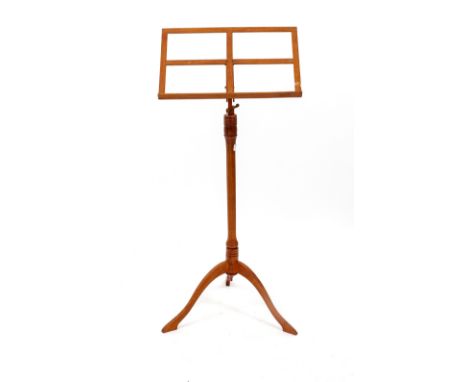 A TURNED HARDWOOD ADJUSTABLE MUSIC STAND on a tripod base, 99cm high (adjustable)