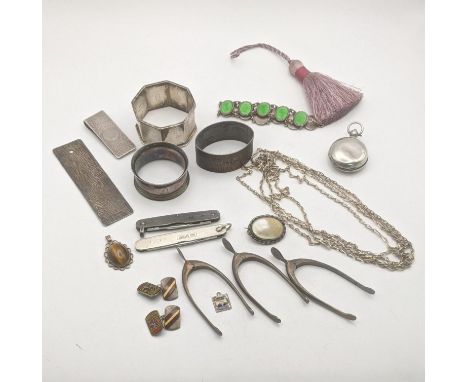 Mixed silver and white metal to include three napkin rings, a sterling silver and enamel bracelet, three pairs of wishbone su