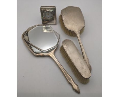 Mixed silver dressing table items to include a hand mirror A/F and two brushes along with a silver cased Kitney & Co. clock L