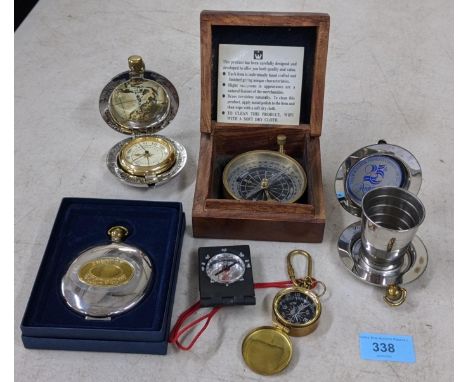 Three compasses, one boxed, the Dalvey Voyager clock in a case, a collapsible pocket dram cup in a case, and a Dalvey pocket 