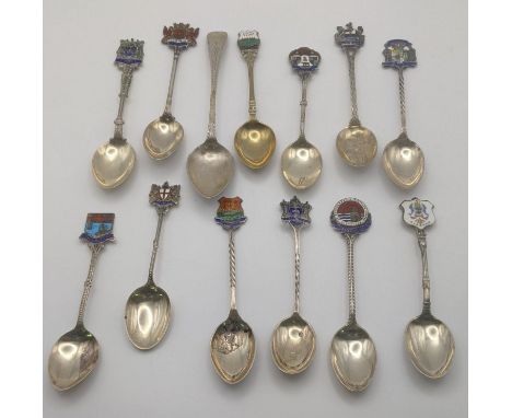 Eleven silver collectors tea spoons, some with twisted terminals and decorated with enamel, to include Leeds, Glasgow and oth