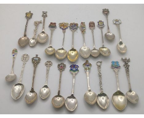 A collection of silver and white metal collectors spoons to include silver spoons decorated with enamel terminals and others,