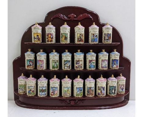 A Lenox Walt Disney fine porcelain jar collection housed within a mahogany wall hanging three tier shelf 47cmH x 59.5cmWLocat