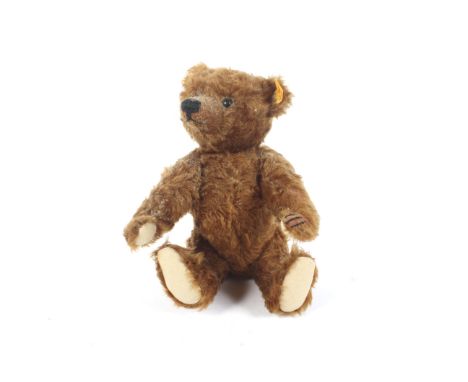 A late 20th Century dark finish Steiff Teddy bear ( wool and cotton covering with jointed arms and legs, articulated head, st