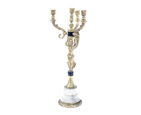 An early 20th century Empire style gilt-metal mounted four-light candelabra. With a winged figure supporting three branches c