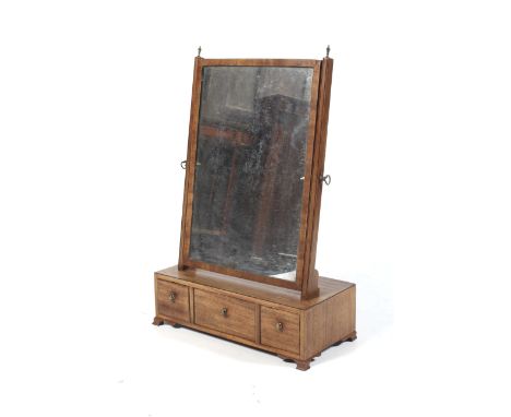 A Georgian mahogany dressing table swing mirror. With rectangular mirror and original plate, above three drawers, with brass 