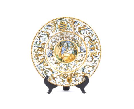 An Urbino maiolica armorial dish, circa 1600, perhaps Patanazzi workshop. Painted with a bearded figure holding an open book 