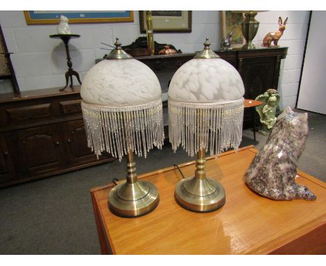 A pair of modern mottled glass table lamps with tassels and a similar standard lamp